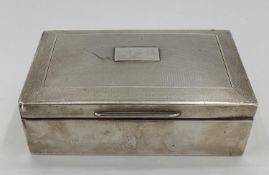 A sterling silver cedar lined cigarette box with engine turned decoration by A J Zimmerman,