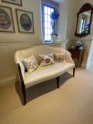 A good show framed settee, upholstered in cream silk fabric, raised on tapered legs to brass drum