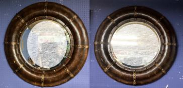 Pair of modern circular porthole style mirrors, bevelled plate with metal bound faux leather frames,