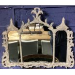 An OKA carved wooden overmantle mirror, three arched plates with carved pierced frame originally