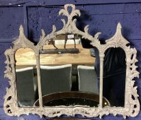 An OKA carved wooden overmantle mirror, three arched plates with carved pierced frame originally