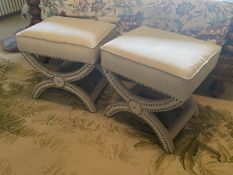 A pair of contemporary X framed brass studded stools, entirely upholstered in a cream fabric