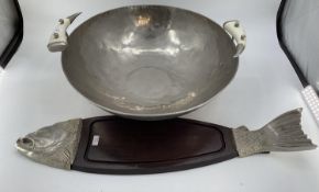 A very large beaten metal style bowl, and a large board styled with fish head and fins