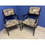 Pair of contemporary black and gilt armchairs, upholstered in an African Safari upholstery, one