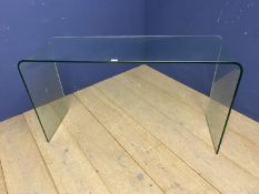 A contemporary glass side table, 125 W x 70cm high approx