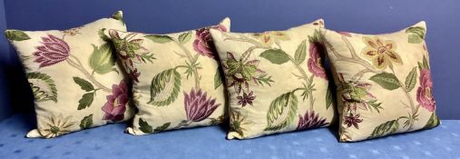 A set of four bespoke good silk and velvet cushions, decorated cream ground and purple and green
