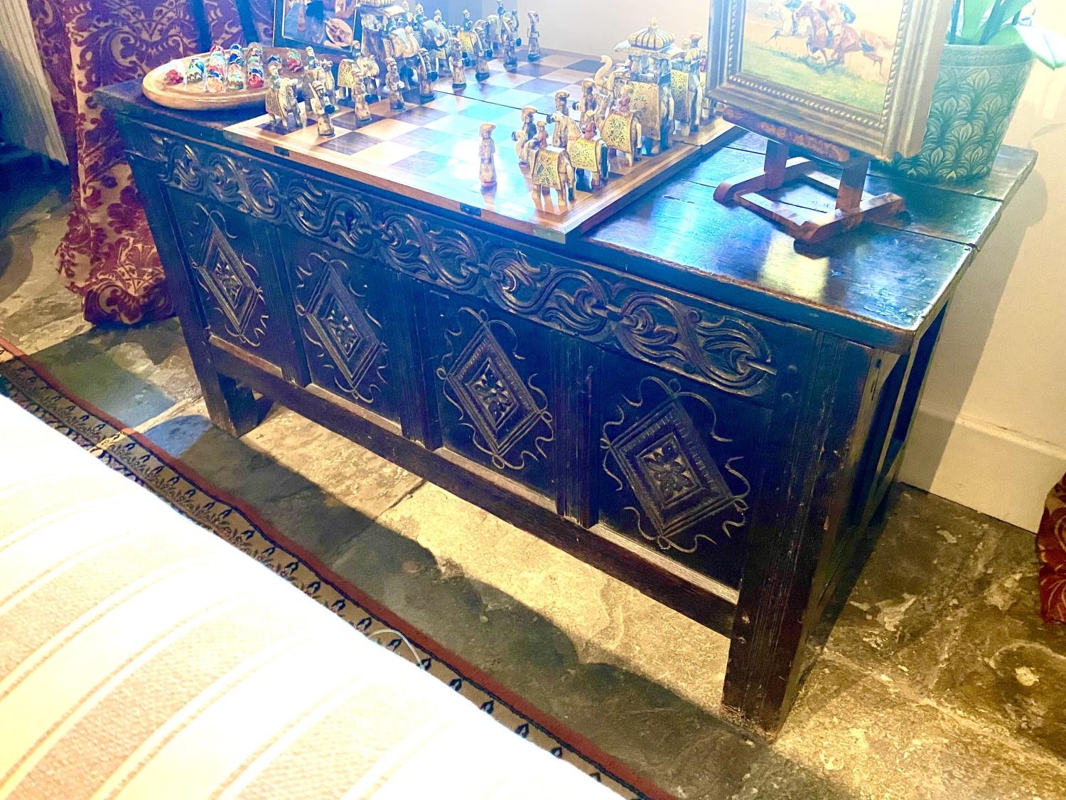 An C18th and later heavy oak plank coffer, with carved front panels and frieze, 138cm Long, 71cmH,