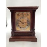 A good late Regency mahogany cased chiming table Clock with fret work and upholstered side panel and