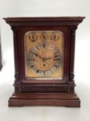 A good late Regency mahogany cased chiming table Clock with fret work and upholstered side panel and