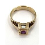 A 9ct gold and ruby ring single round free cut ruby in a raised box bezel mount, 3.65g