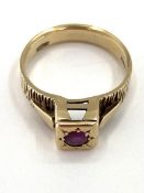 A 9ct gold and ruby ring single round free cut ruby in a raised box bezel mount, 3.65g