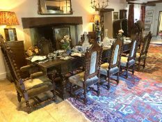 A good set of 10 (8 + 2 carvers) Jacobean style heavily carved mahogany high back dining chairs,