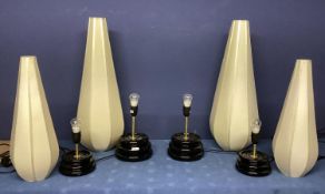 Four similar small black lamps, with modern tall conical style cream shades