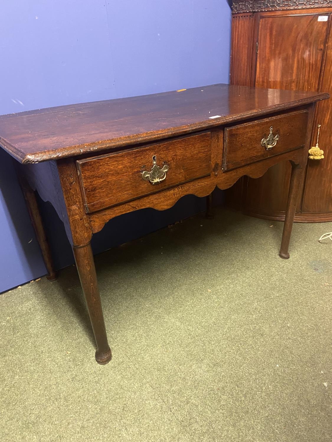 Georgian country made oak, side table of two drawers, on turned legs and shallow bun feet.