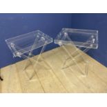 Pair of plastic bedside tables, with X framed folding base and tray tops