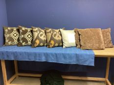 Eight cushions: in brown linens, velvets and creams etc, including 4 patterned OAKA cushions, and