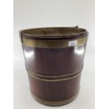 A good mahogany and brass bound bucket, wit brass liner and carrying handle, 32cm H