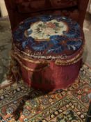 A Victorian drum stool, with a upholstered tapestry seat, some wear
