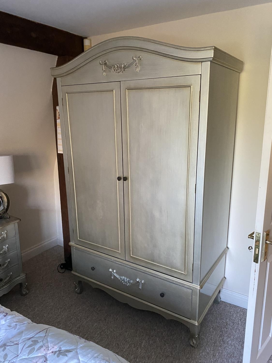 Matching bedroom suite comprising of : Decorative Two door wardrobe, on raised legs with floral
