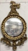 A Regency giltwood convex Girondelle mirror, surmounted by mythical seahorse on rocky outcrop with