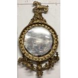 A Regency giltwood convex Girondelle mirror, surmounted by mythical seahorse on rocky outcrop with