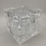 A stylistic cubed ice bucket, with hinged lid, opening to reveal glass liner interior, retails