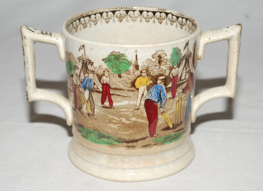 'Village cricket'. A Victorian Staffordshire loving cup, printed in black/brown with two different - Image 2 of 2