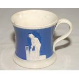 Staffordshire blue ground waisted cricket mug with strap handle and beaded rim. With three relief