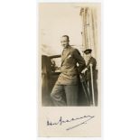 Don Bradman. Mono candid photograph of Bradman getting in to a car, signed to the lower border in