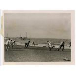 Cricket at sea. Original mono press photograph of an unusual game of cricket taking place on