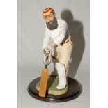 ‘W.G. Grace’. Large stone ware resin figure of Grace wearing M.C.C. cap and belt playing a forward