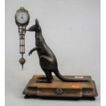 A 20th century bronze novelty mystery clock, in the form of a kangaroo, mounted upon a walnut