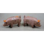 A pair of painted cast iron piggy-banks, h.10cm