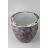 A large modern Chinese style jardiniere, enamel decorated with leaves and flowers, h.33cm