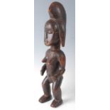 An ancestor figure, carved as a nude female in standing pose, Punu People, Gabon, early-mid 20th