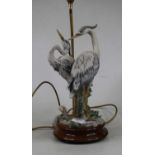 An Italian table lamp modelled as two herons upon a turned beech plinth, height 68cm including