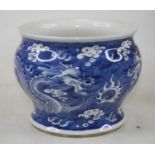 A Chinese blue and white glazed stoneware jar, the flared rim above a squat globular body
