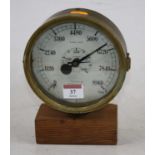 An early 20th century brass pressure gauge, mounted upon a pine plinth,dia.16cm