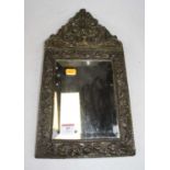 A 19th century Flemish brass wall mirror, repousee decorated with flowers and C-scrolls, having a