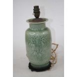 A 20th century Chinese celadon glazed vase decorated with fruit within a spearhead border, converted