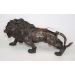 A bronze model of a prowling lion, h.15cm