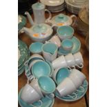 A 1970s Poole pottery two-tone coffee and tea service, on a grey ground with turquoise interior,