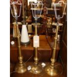 A set of three contemporary brushed brass turned table lamps, with shades, h.62cm (excluding