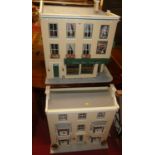 A painted three storey dolls house, with hinged front panel and various interior decorated rooms,