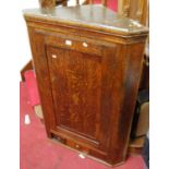 A 19th century oak and mahogany crossbanded hanging single door corner cupboard