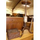 An oak pedestal wine table; together with a rustic octagonal topped milking stool; and a relief