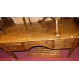 A contemporary oak and burr oak round cornered kneehole writing desk, having an arrangement of