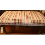 A contemporary striped upholstered twin footstool, raised on turned and reeded oak supports,