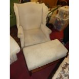 A contemporary cream upholstered wing back arm chair, raised on square moulded forelegs, width 94cm,