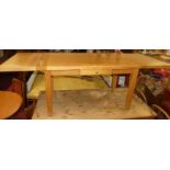 A contemporary light oak refectory table, having drawleaf end attachments, single frieze drawer, and